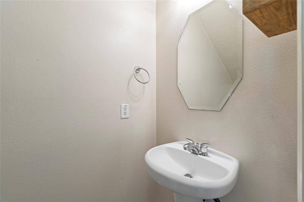 This thoughtfully placed half bath offers privacy and convenience for visitors, with fresh finishes and easy access from the main living areas.