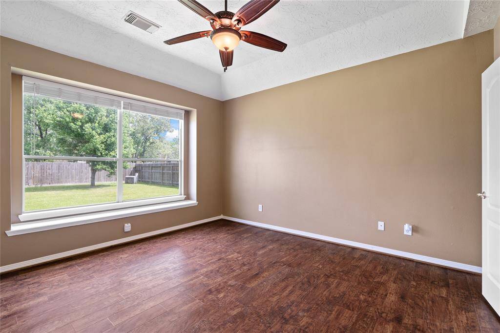 Tucked away for added privacy, the primary bedroom is a spacious sanctuary featuring a calming color palette, while giving you the ability to enjoy the tranquil atmosphere of your backyard.