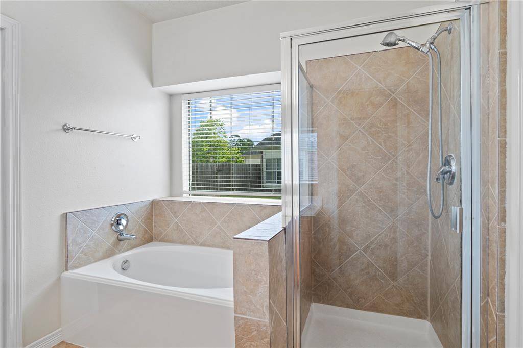 The primary ensuite offers a spa-like retreat featuring dual vanities, a relaxing soaking tub, and a separate glass walk-in shower for your choice of comfort.