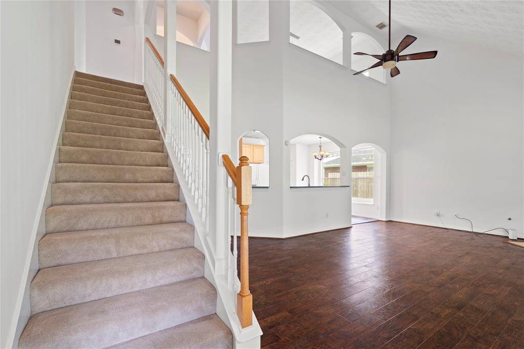 The open staircase blends beautifully into the home’s layout, leading to the upper level where you’ll find a spacious flex area and private secondary bedrooms. Ideal for family living or guest accommodations.