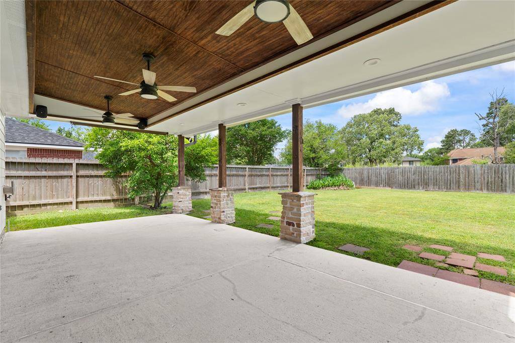 Enjoy the outdoors in comfort on the covered back patio, offering a great space for grilling, relaxing, or hosting gatherings. Featuring three outdoor fans to keep you cool on the Summer days with speakers ready to entertain.