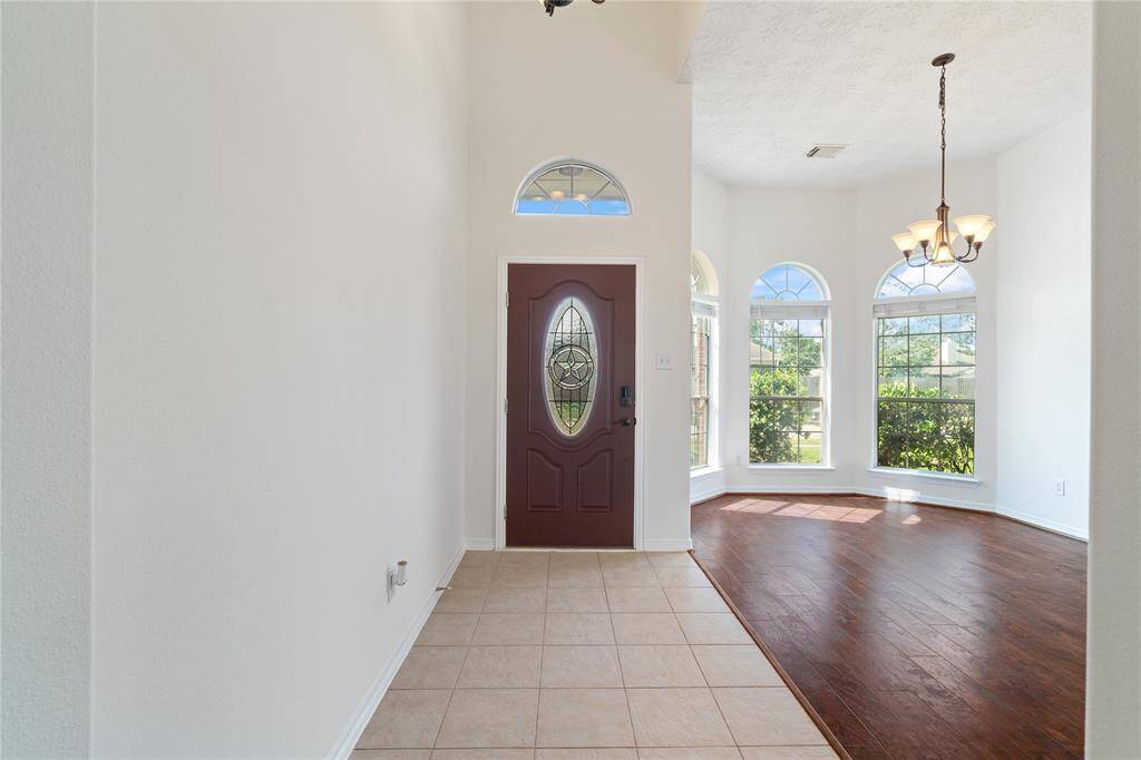 Step into a welcoming entryway that flows seamlessly into a spacious formal dining room featuring rich LVP flooring that adds warmth and character.