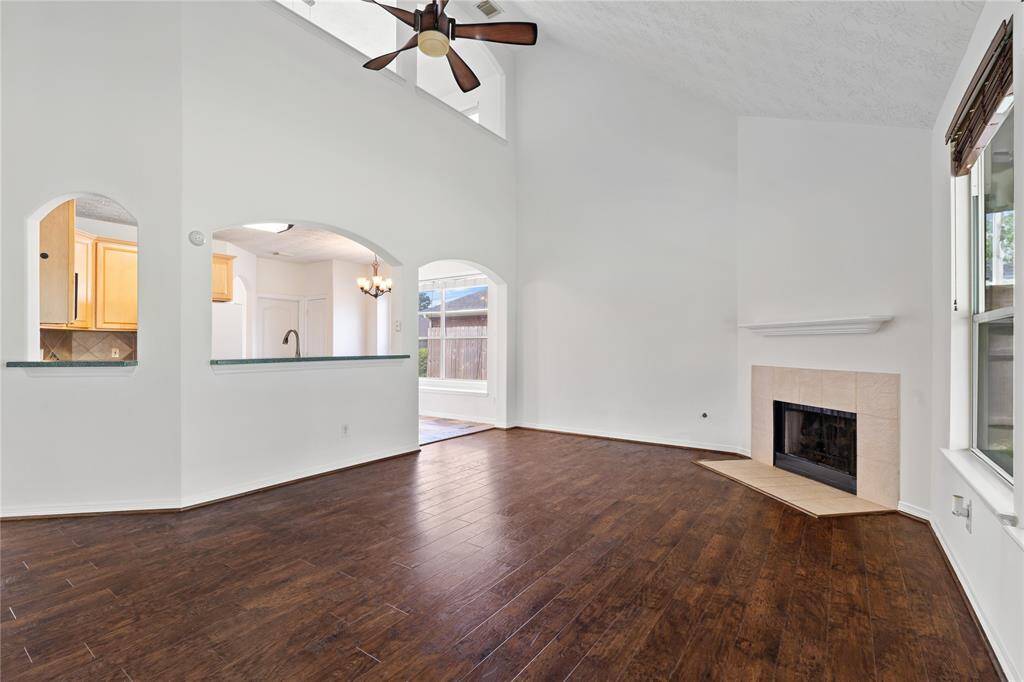 Anchored by a beautiful fireplace, the living room offers high ceilings and fresh neutral tones to complete the space, blending charm and function for everyday living.