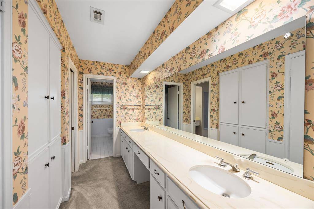Primary bath has double sinks and walk-in closet