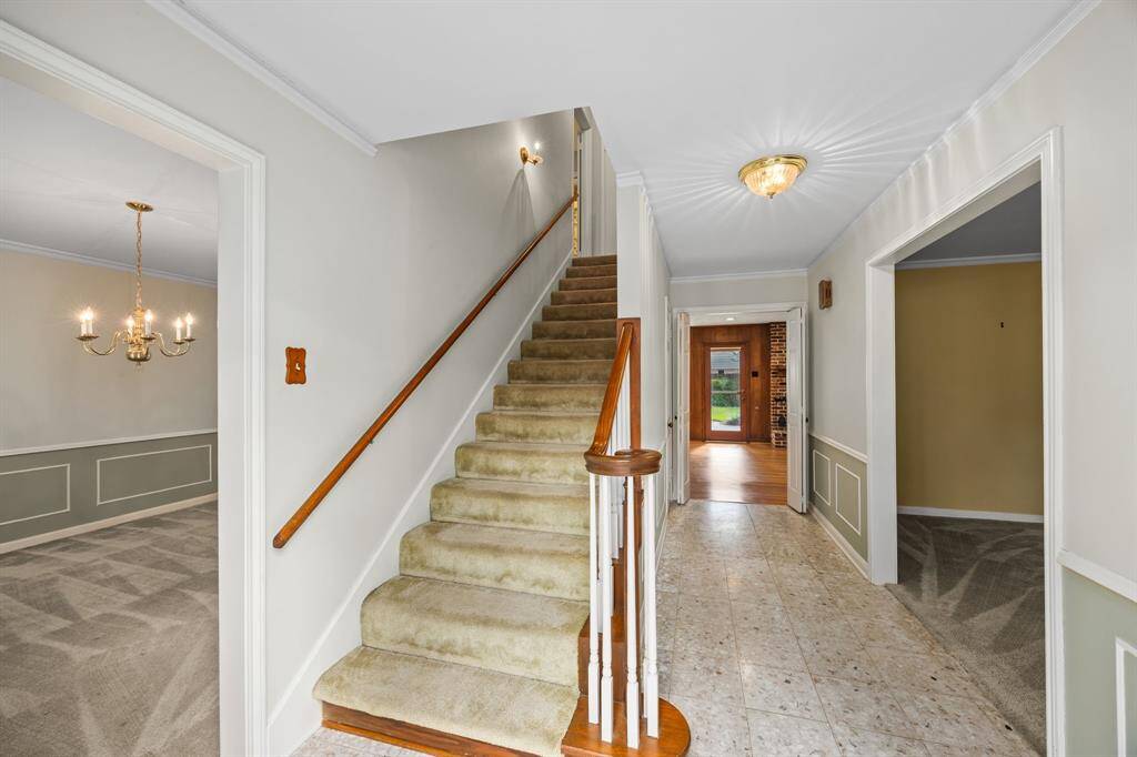 Entry has terrazzo tile floors and wainscotting