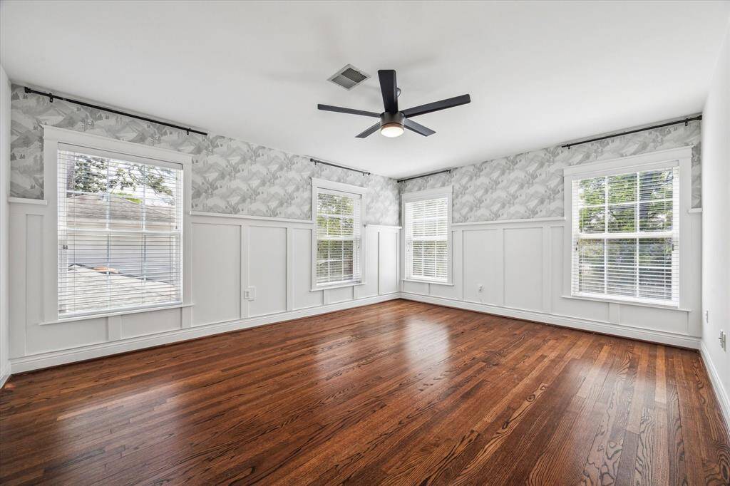Such a pretty bedroom with wallpaper and wainscoting!