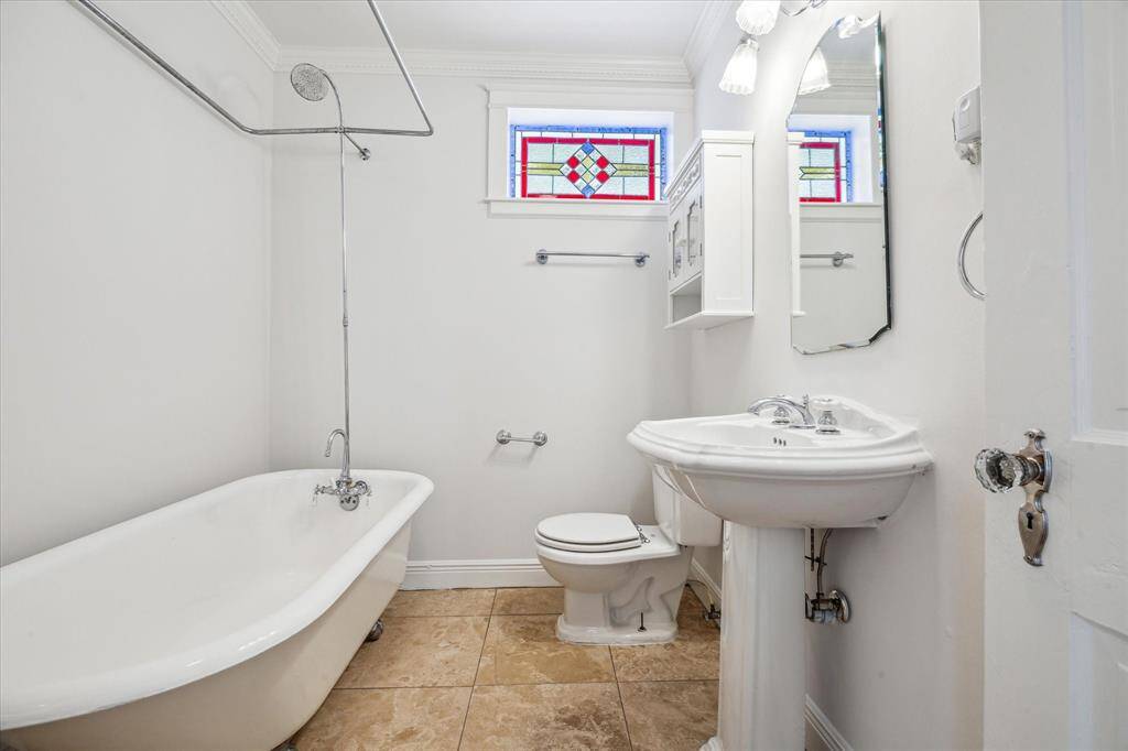 Second floor bathroom, note the stained glass window, this one has kept all the charm of the 1945 build date!