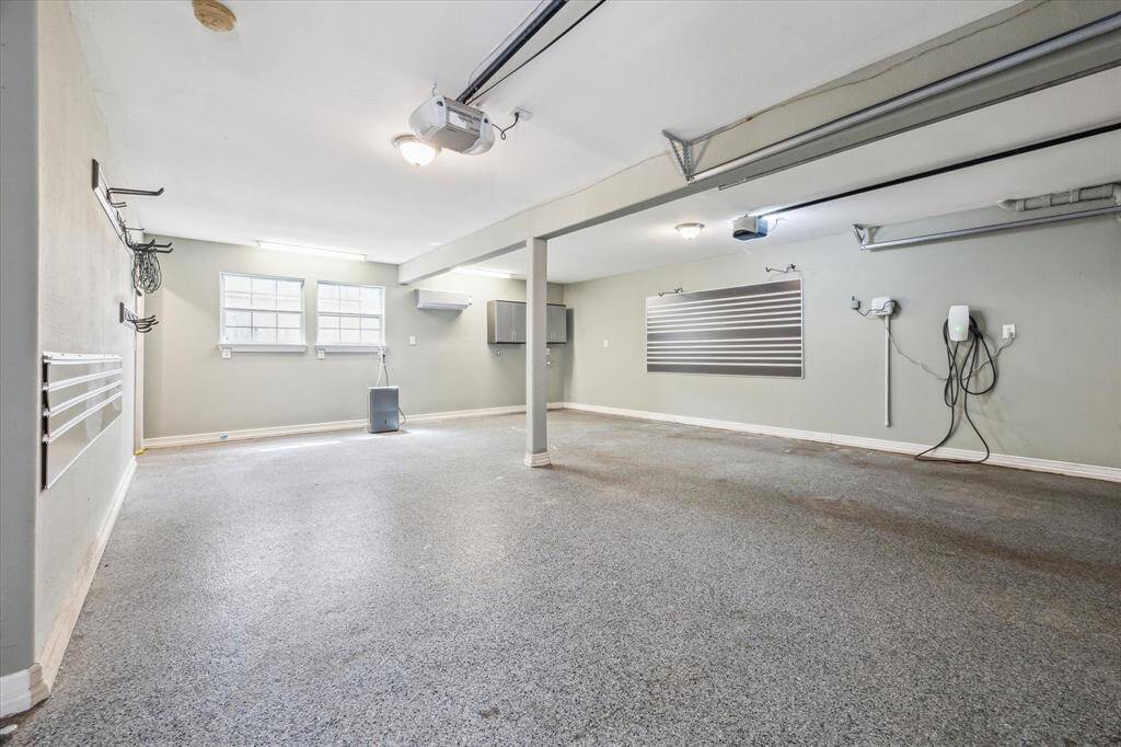 Huge garage with extra parking and it is air-conditioned! Previously used a a gym!