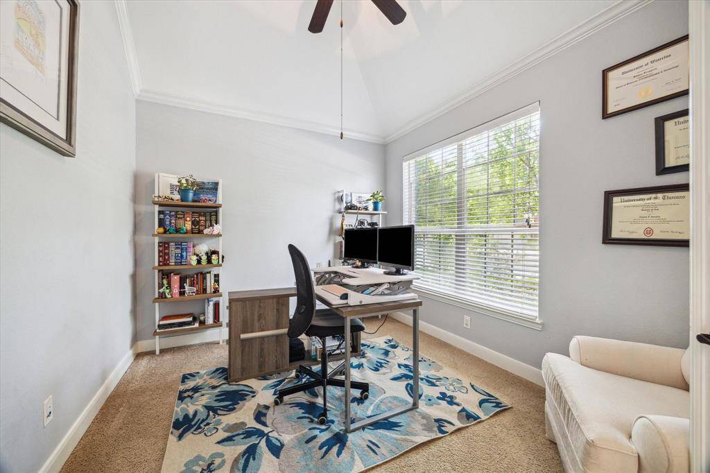 This photo showcases a bright home office with a large window providing ample natural light.