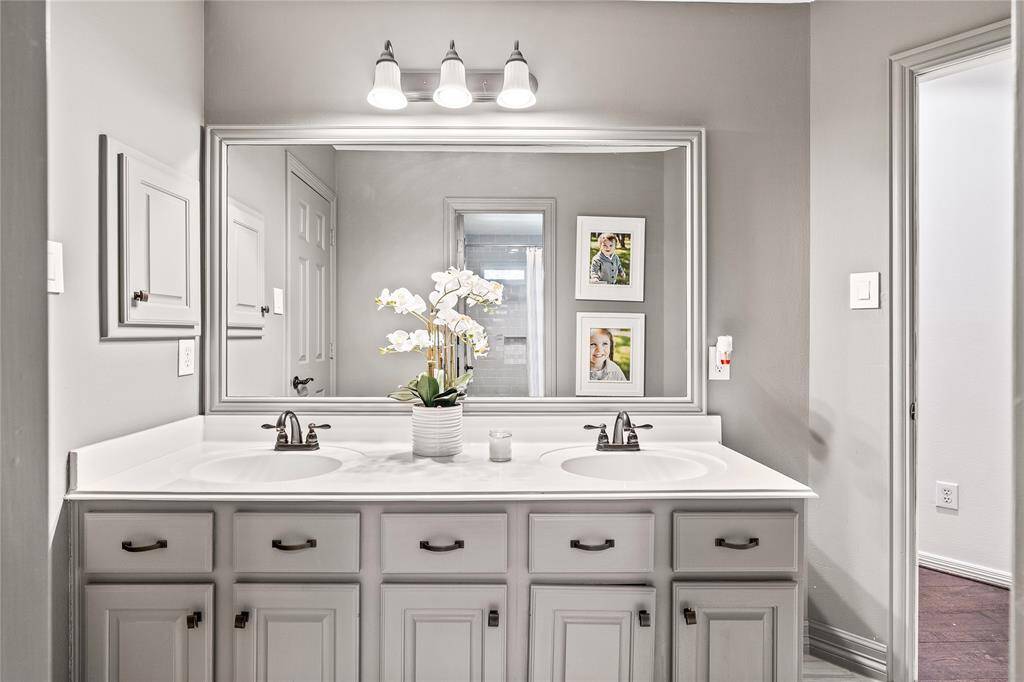 Another view of closet showcasing custom vanity with lighted mirror and TV.  A dream space to get ready for your gala or special event.