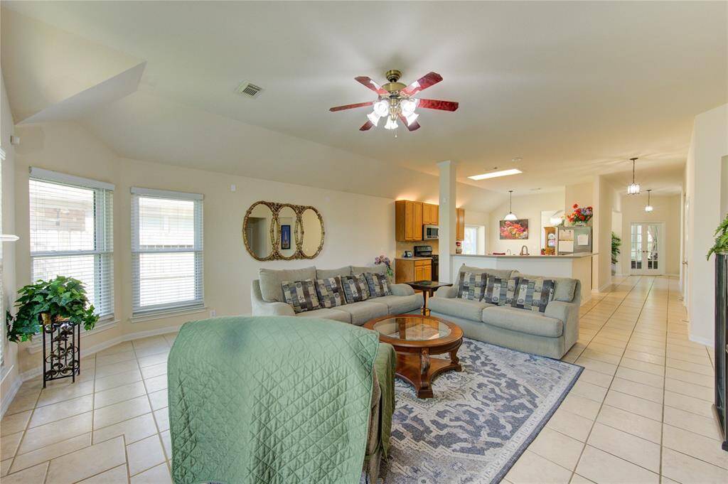 This open-concept family room provides generous space and effortless flow into the kitchen, creating the perfect setting for gathering, relaxing, and entertaining.
