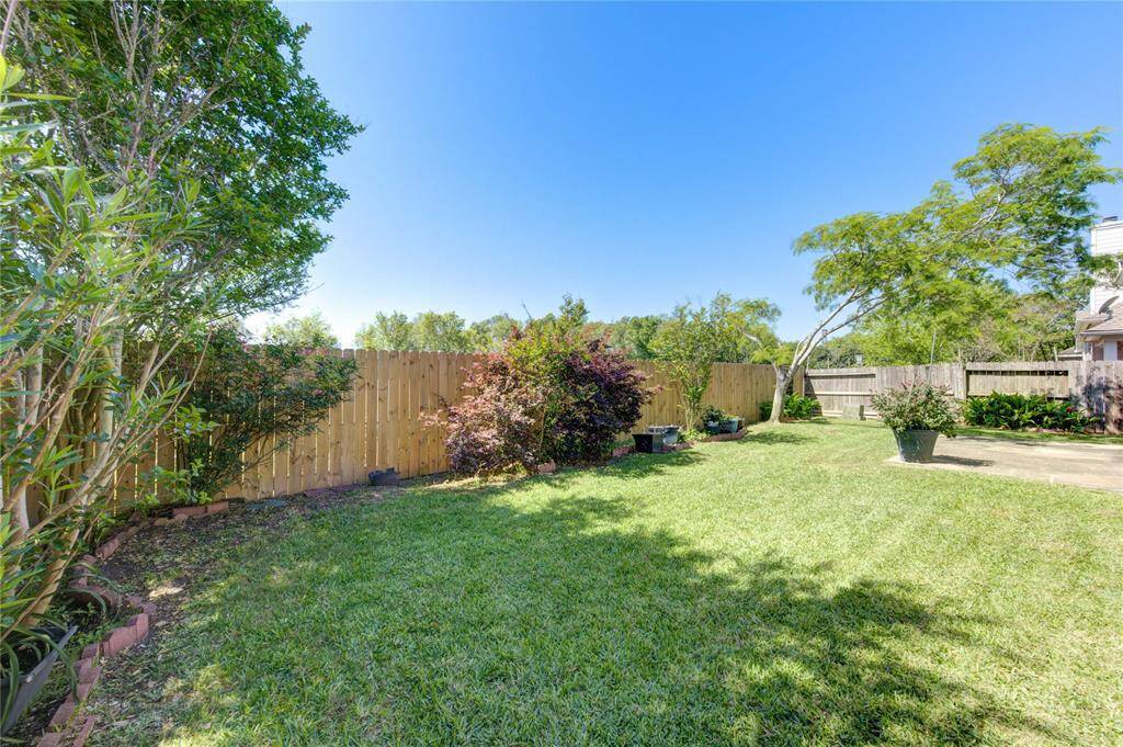 Beautifully maintained backyard with vibrant green grass—perfect for play, entertaining, or simply unwinding outdoors.
