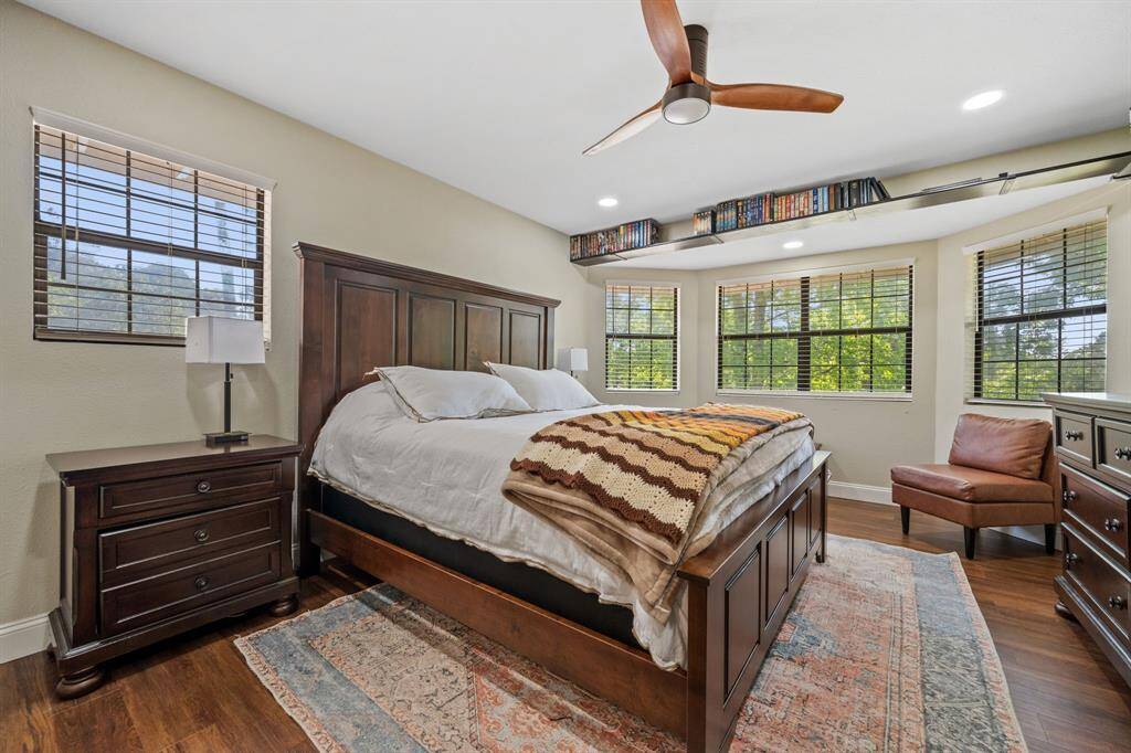 On the other side of the staircase is this great sized primary bedroom with its own bathroom with double vanity