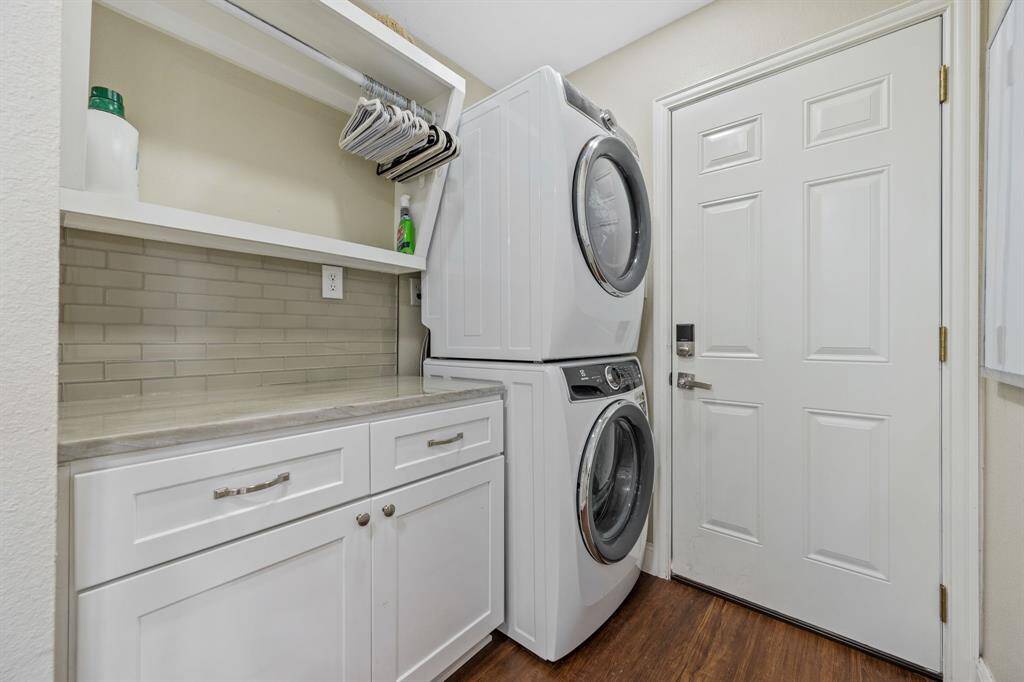 The side entry connected to the carport leads into the utility area. This lovely space offers storage and beautiful counterspace that doubles as an area to fold clothes or convenient landing zone for bringing in groceries.