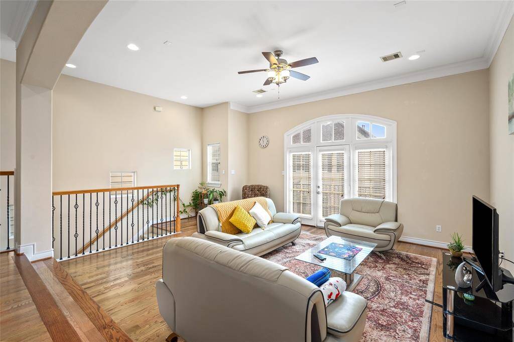 Another angle of the living area. The floor-to-ceiling windows and the light, neutral wall tones create a bright and airy atmosphere.