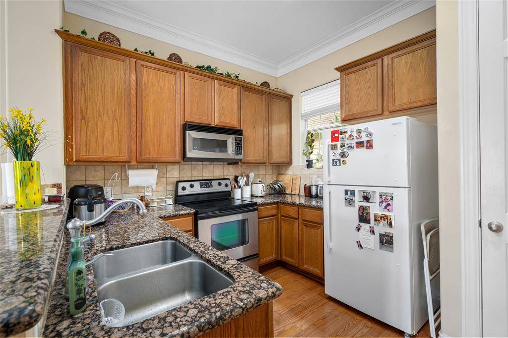 Well-organized kitchen with abundant cabinetry, generous counter space, and a functional layout ideal for home cooking. A pass-through opening to the dining area adds connectivity while maintaining separation.