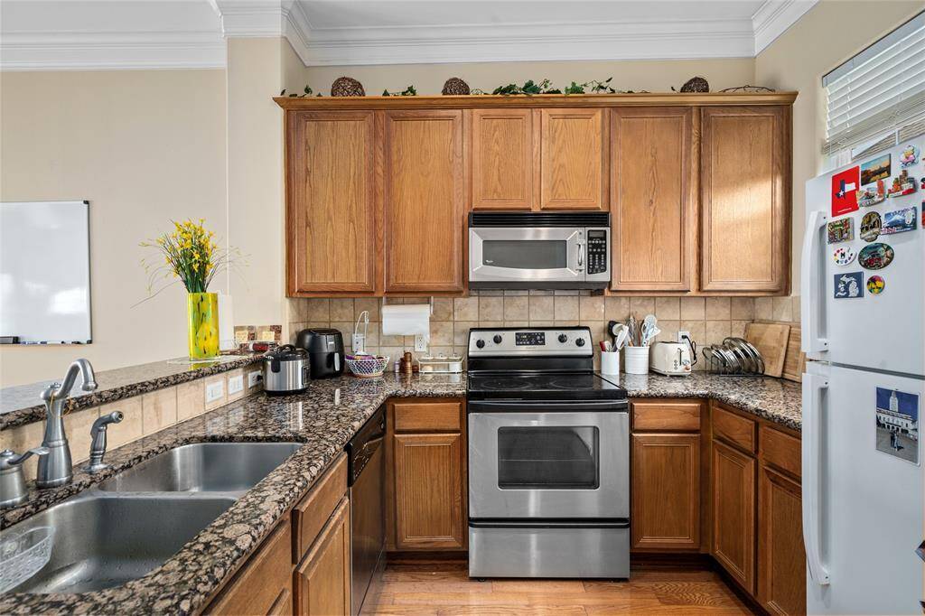 Efficiently designed kitchen featuring ample cabinetry and spacious countertops, creating an ideal setup for preparing meals.