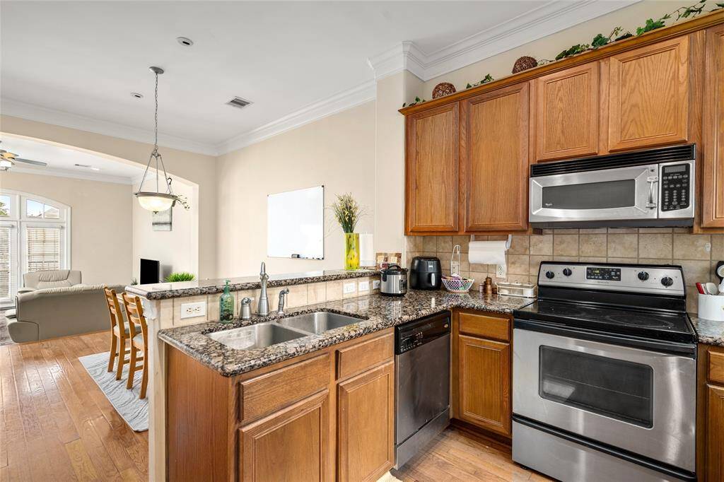 The thoughtful layout ensures ease of use, while a pass-through window to the dining area enhances flow without sacrificing privacy.