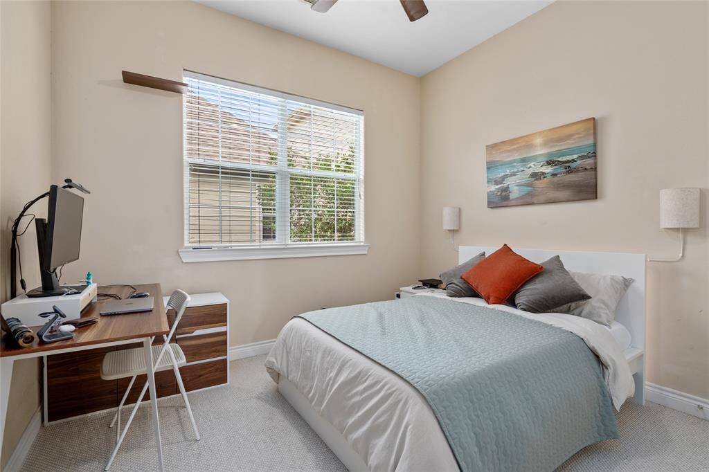 This additional bedroom is generously sized and features a large window and closet, perfect for guests, a home office, or a roommate setup.