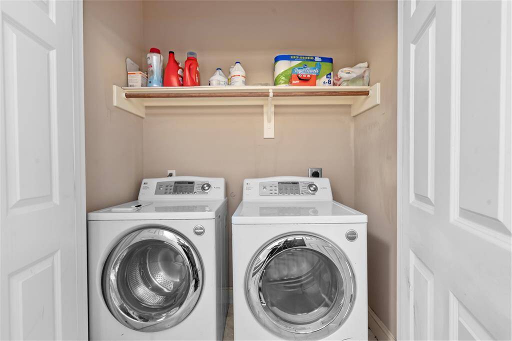 Dedicated laundry space tucked away for convenience, offering practical room for a full-size washer and dryer.