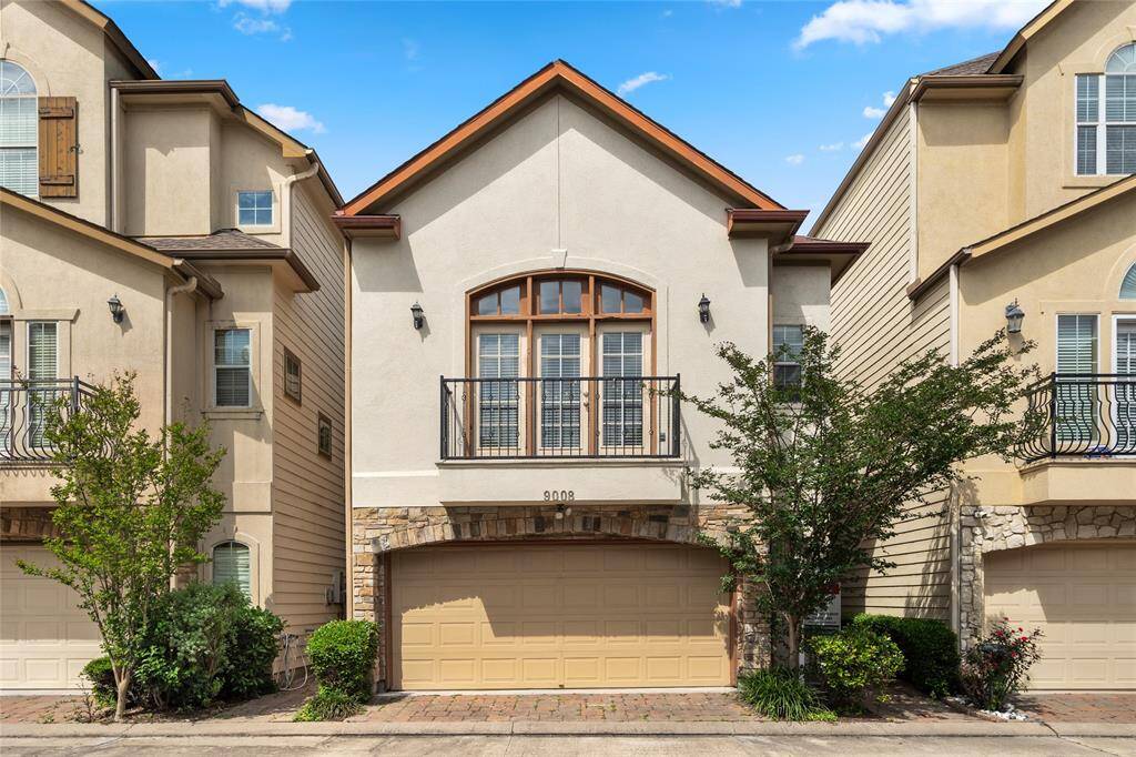 Charming townhome entry with classic curb appeal and mature landscaping. A quiet, established community setting just moments from city conveniences.