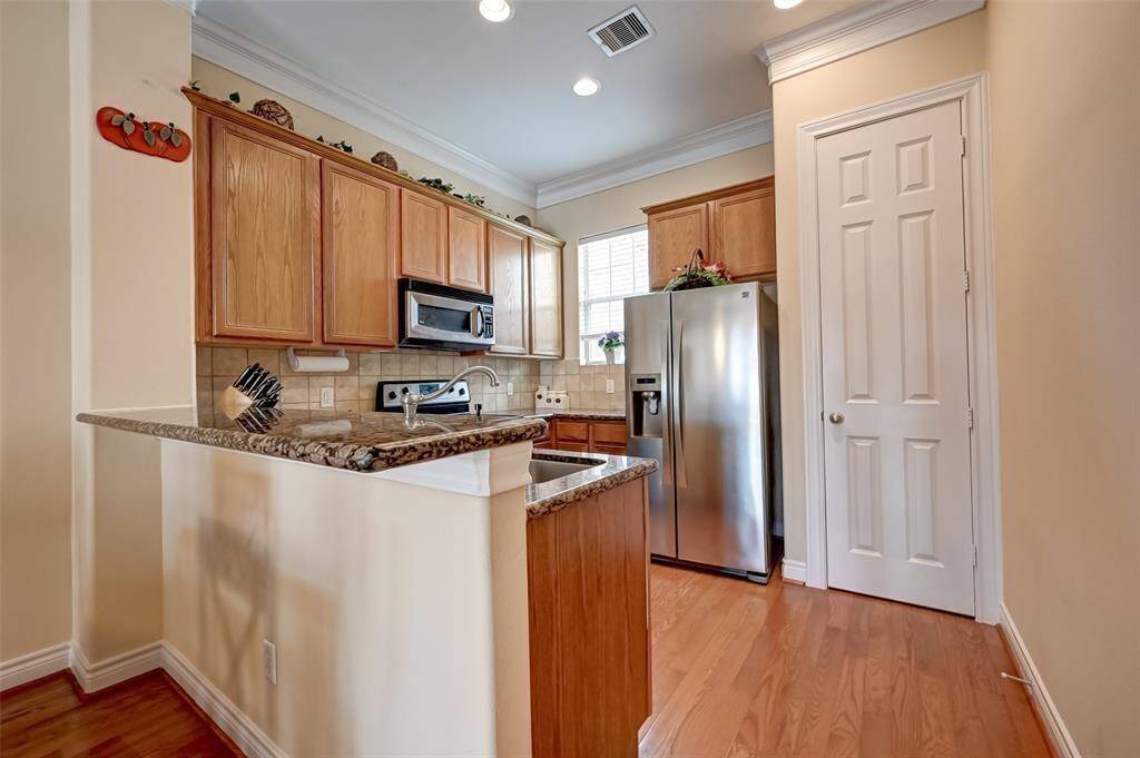 Upon entry, you're greeted by a clean, tiled foyer with direct access to the attached garage and a carpeted staircase leading to the main living areas. Natural light filters in from a high window, giving the space a warm and welcoming feel.