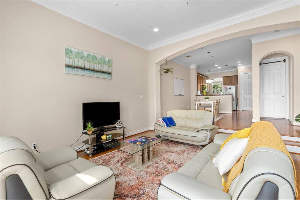 The second floor boasts an open-concept layout that combines the living room, dining area, and kitchen into one cohesive, light-filled space—ideal for both everyday living and entertaining. The seamless flow between rooms creates an airy, connected atmosphere, with windows bringing in natural light and enhancing the sense of spaciousness. Whether you're relaxing in the living area, hosting dinner, or prepping in the kitchen, the design keeps everything—and everyone—within reach.