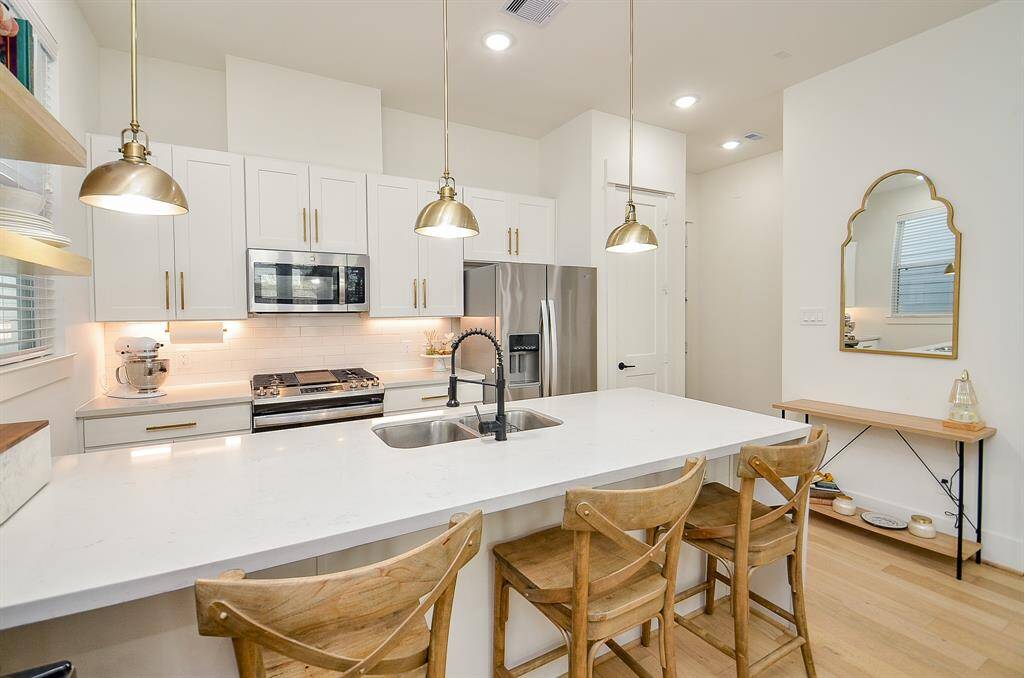The light, bright kitchen is open to the dining and living space.