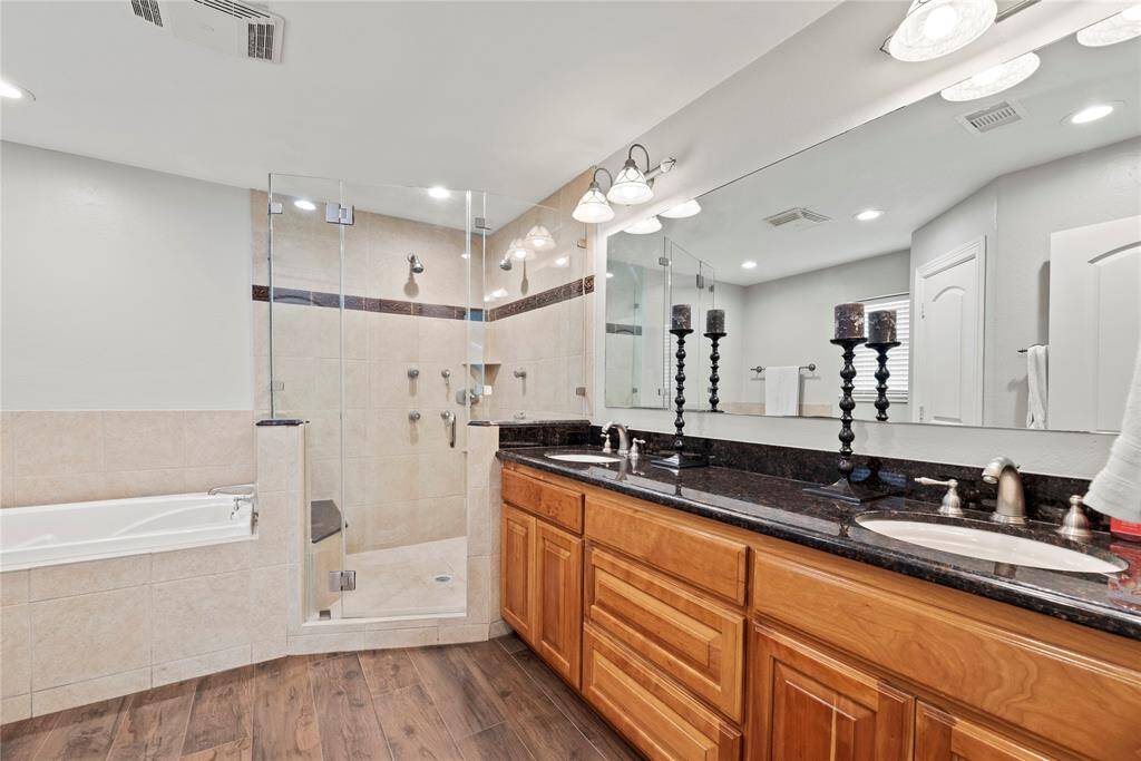 Dual sinks ensure both partners have a dedicated area for grooming and self-care! Ample counter space is only enhanced by the tremendous space beneath, which includes multiple drawers of varying sizes and base storage cabinetry!