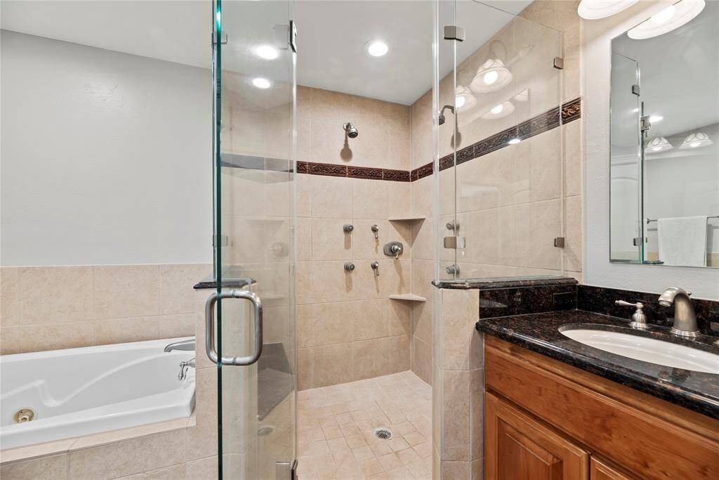 Matching tile work in the shower provides consistency in design.