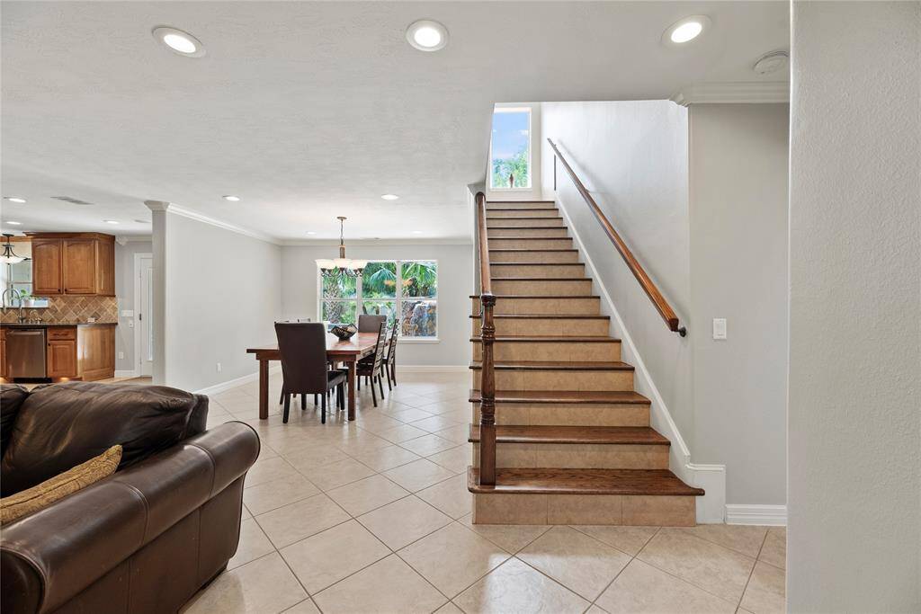 Recessed lighting creates a bright and illuminated interior. Providing a stunning contrast between the deep vanilla walls and the richly toned flooring, the glistening light enhances the appealing color scheme.