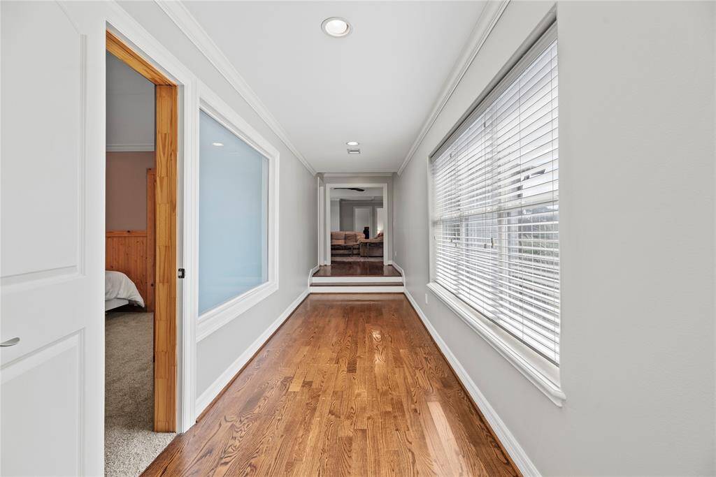 Recessed lighting creates a bright and illuminated interior. Providing a stunning contrast between the deep vanilla walls and the richly toned flooring, the glistening light enhances the appealing color scheme.
