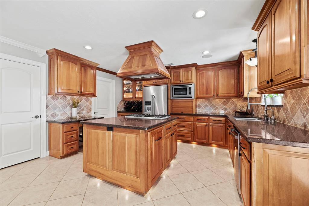 Boasting impressive storage, the center island also features an outlet for easy mixing and prepping with small kitchen appliances. Store cookie cutters and cupcake supplies beneath for impromptu baked goodies, which of course always require an urgent need!
