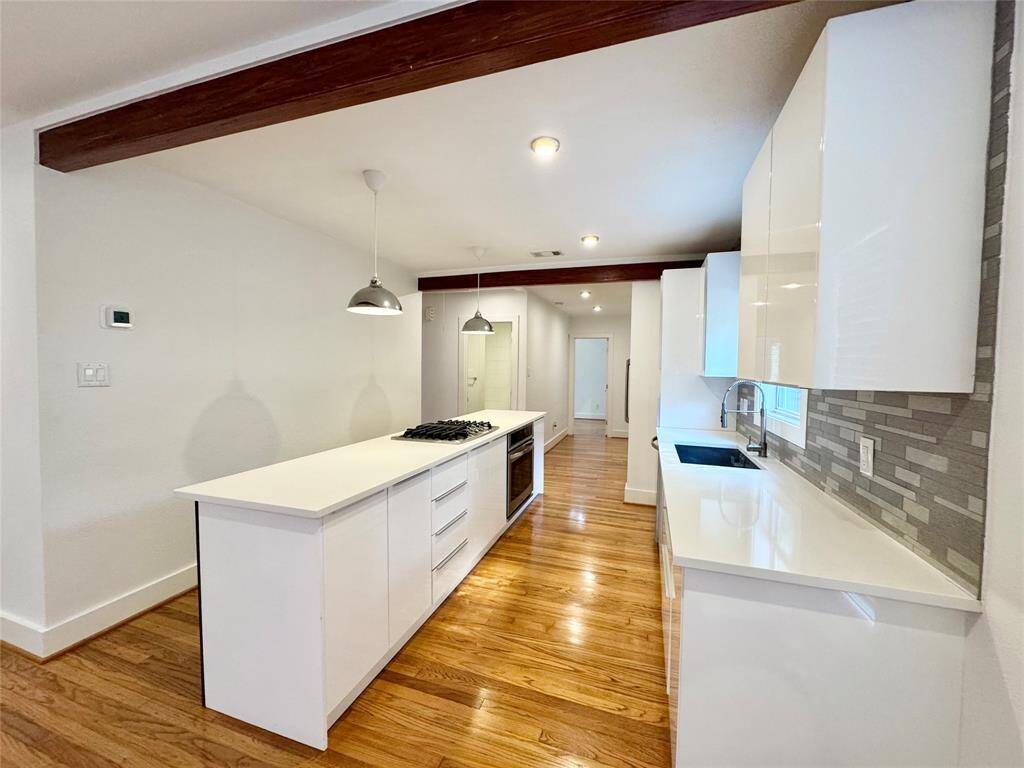 Kitchen has been modernized with slick countertops and cabinets!