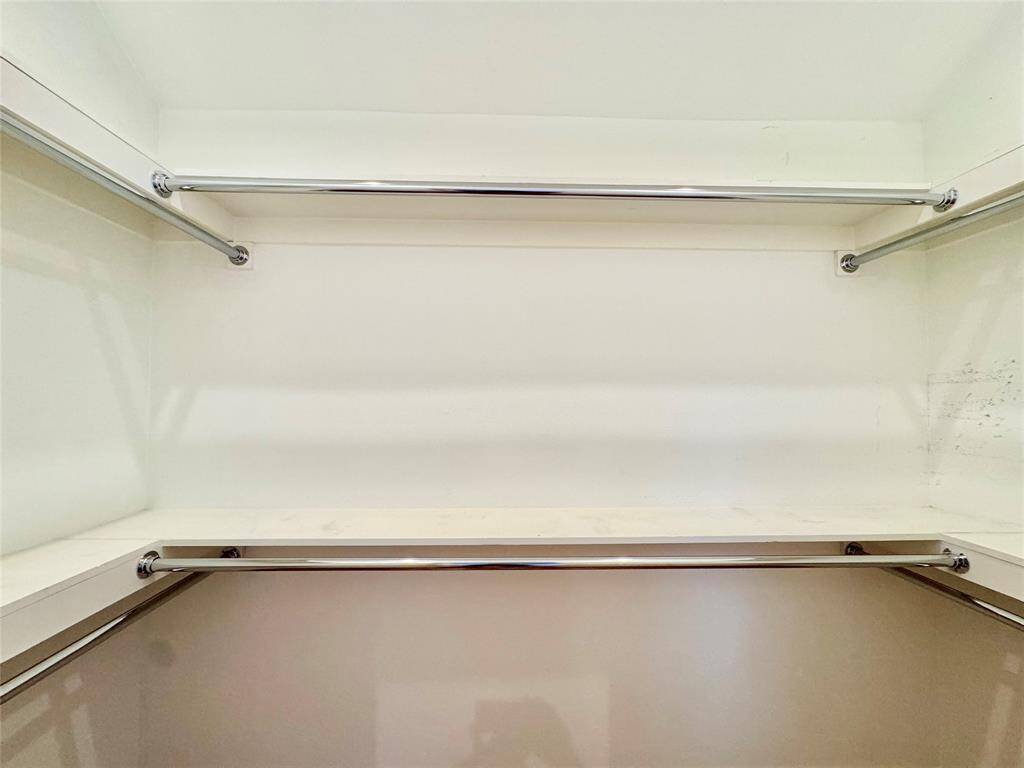Spacious walk-in closet has plenty of space for hanging clothes!
