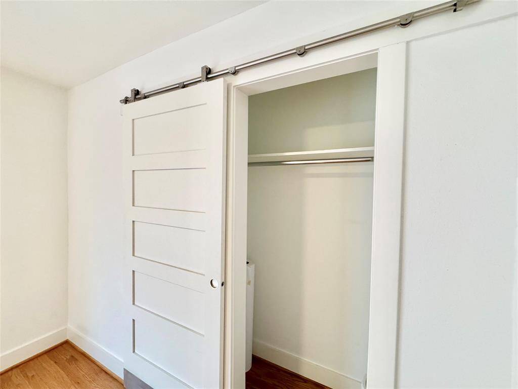 Behind a cute barn door is a good-sized closet!