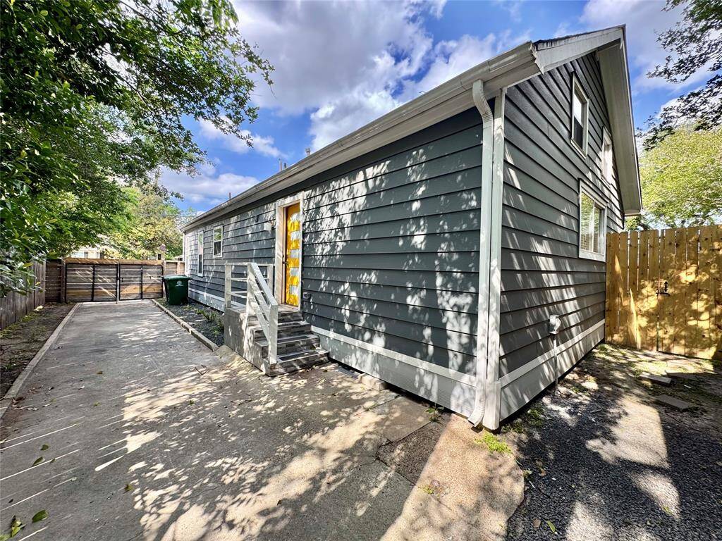 Around the back corner of the house is access to the fenced back yard!