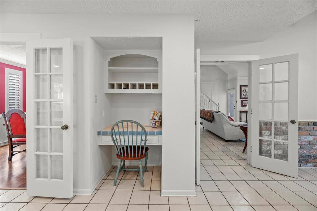 Home desk nook with built-in shelving in the kitchen.  Great as a home bill pay station.  This area could easily be changed into additional kitchen or pantry storage.