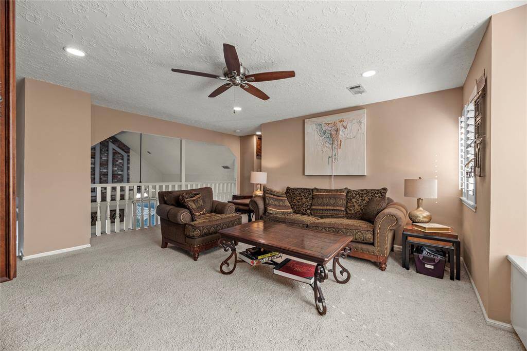 Game Room on the second level features carpet flooring and ceiling fan.