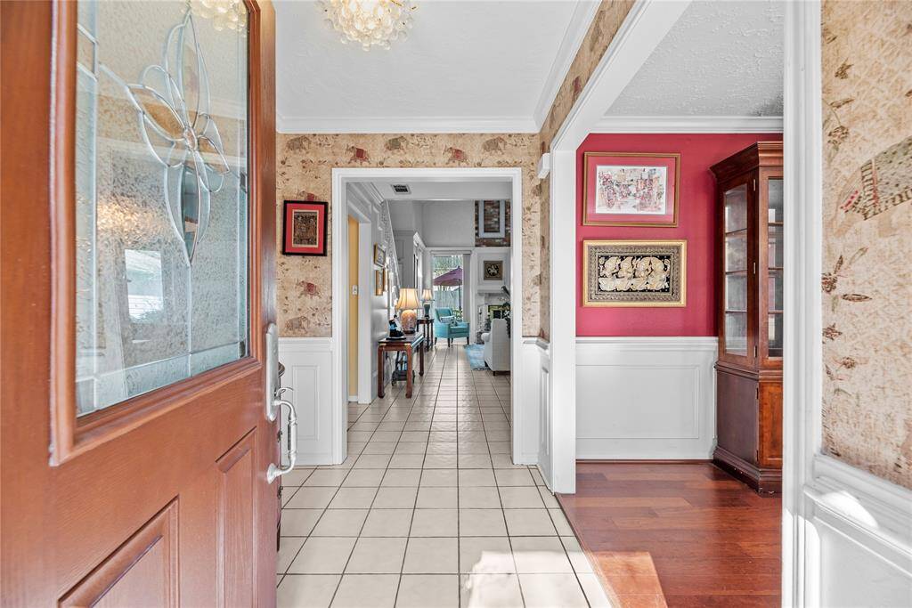 View from the entryway, showcasing the living room straight ahead and the dining room to the right. The open layout creates a welcoming and seamless flow throughout the home.