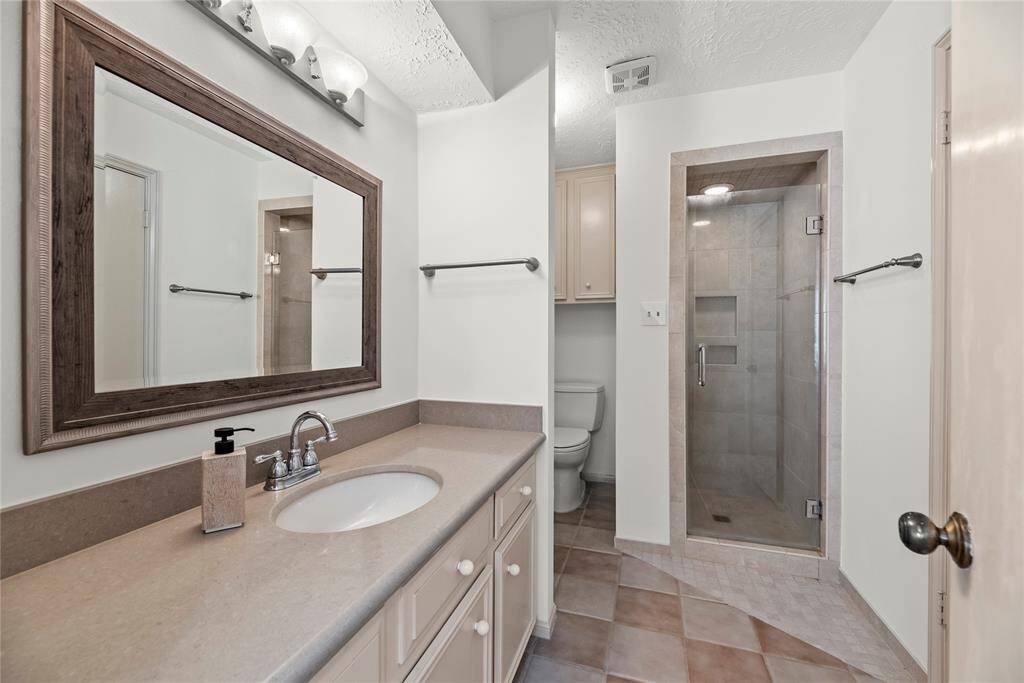 Bathroom # 3 on the second floor with a walk-in shower, sink and vanity area.