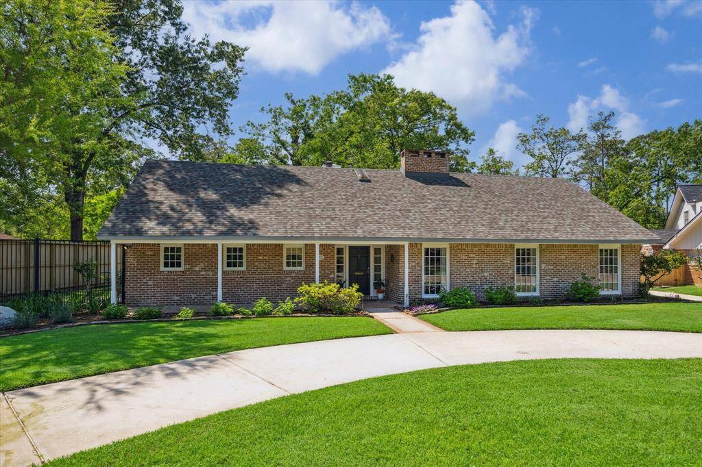 An elegant aerial view captures the stately circular driveway and timeless brick façade of this distinguished residence. A brand-new roof, replaced in 2024, offers both peace of mind and elevated curb appeal. This exceptional home exudes classic charm and architectural presence from above.