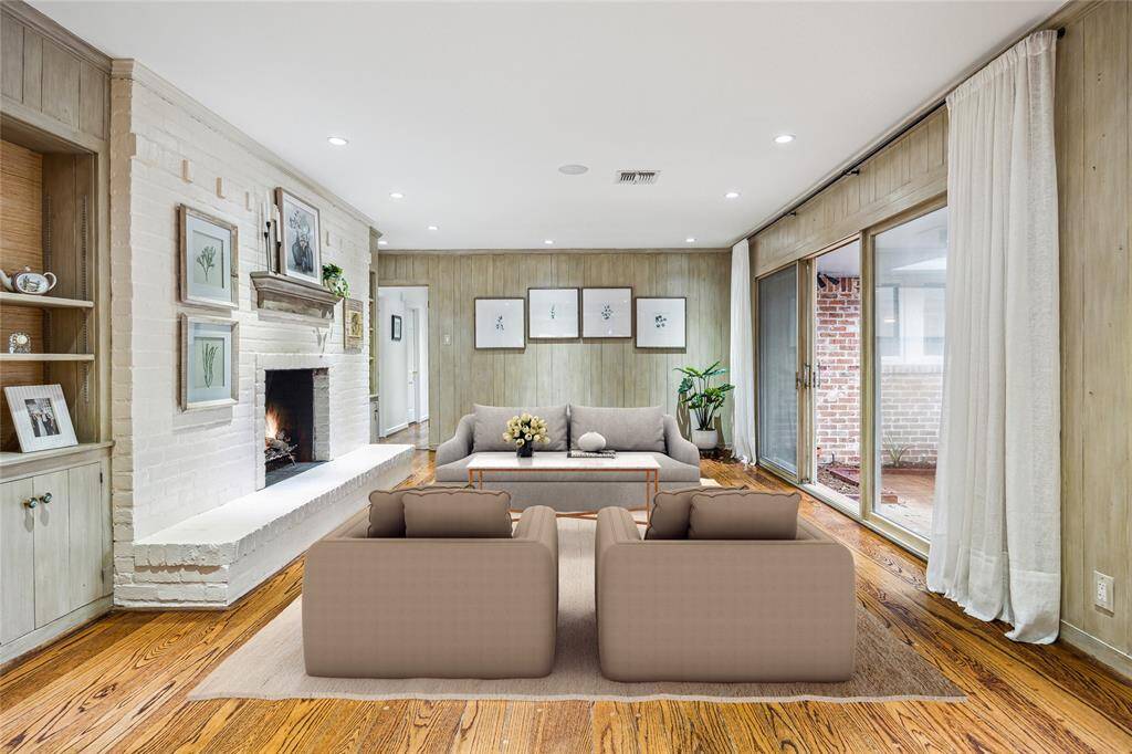 Currently styled as a formal dining room, this richly paneled space features Segreto custom wall finishes and original wood flooring. Sliding doors open to the back patio for effortless indoor-outdoor flow. Timeless elegance and modern comfort come together in perfect harmony.
