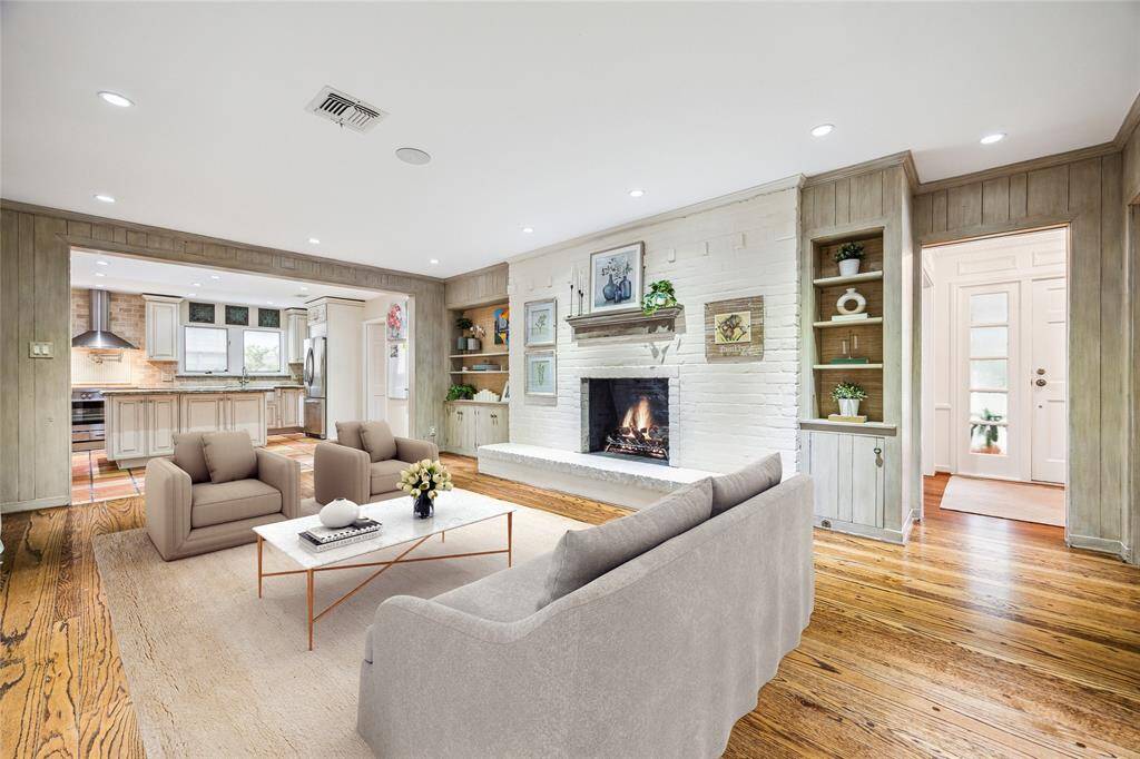 The family room exudes comfort with original hardwood floors, custom Segreto finishes, and recessed LED lighting throughout. Large sliding doors provide effortless access to the rear patio. A warm and elevated space that invites both relaxation and entertaining.