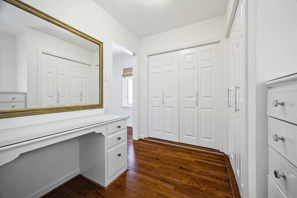 A custom-built vanity connects the dressing area to the primary bathroom, creating a seamless morning ritual experience. Elegant finishes and thoughtful storage elevate daily life. Beauty meets function in this tailored space.