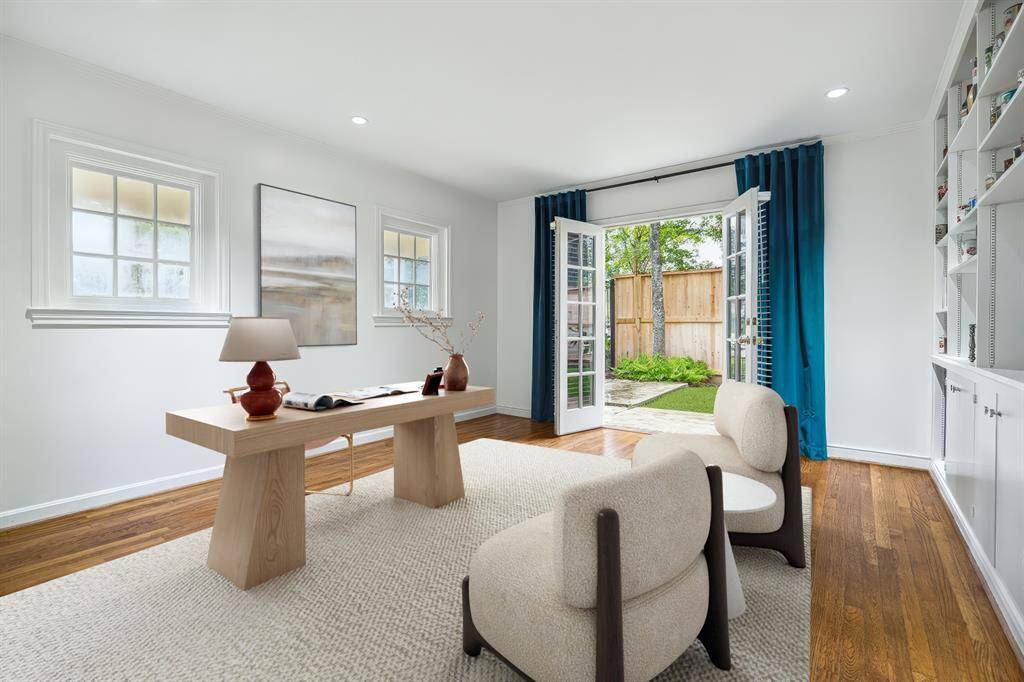 French doors open from the study to a lush, gated side yard, with large windows bringing in natural light and garden views. This bright and tranquil space inspires creativity and focus. A seamless connection to nature and comfort makes it a standout retreat.