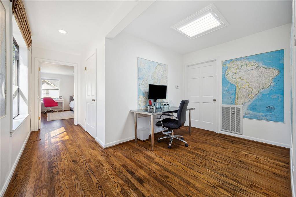 A graceful staircase leads to the upper-level suites and an additional study nook, ideal for working from home. Thoughtfully integrated storage beneath the stairs enhances practicality. This transitional space perfectly balances beauty and utility.
