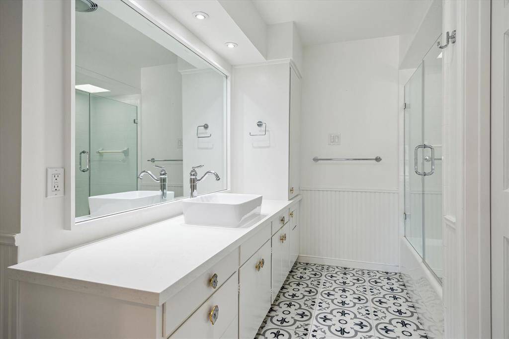 This upstairs suite offers the comfort of recessed lighting, ceiling fan, and an airy trio of windows. It mirrors the elegance and size of its neighboring suite. Designed for privacy, peace, and flexible use.
