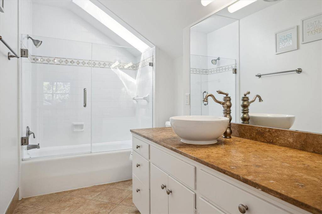 Bathed in natural light from three windows, this secondary bedroom feels bright and airy. Recessed lighting and ceiling fan add modern convenience. Spacious and serene, it’s one of only two bedrooms on the second floor.