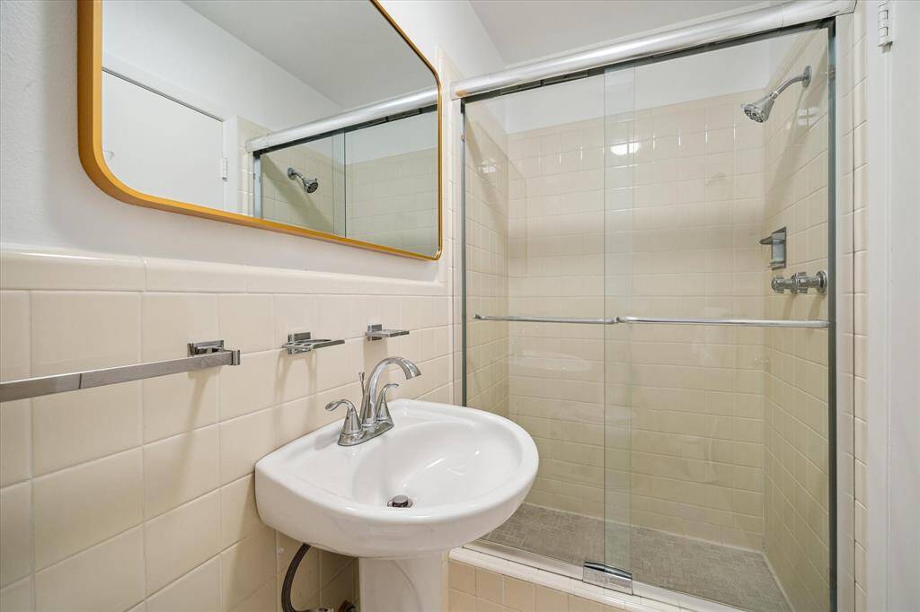 The guest house bedroom offers dual windows, dual closets, and plush carpeting underfoot. Perfect for long-term visitors or in-laws, it provides privacy and convenience. A tranquil space just steps from the main residence.